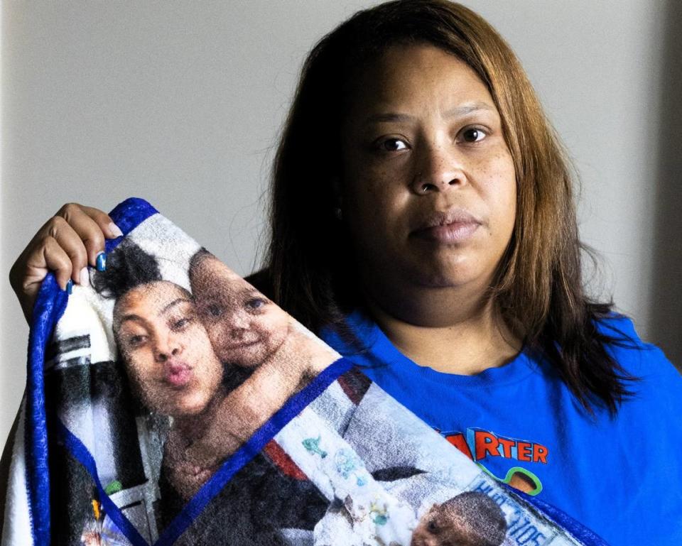 Tiffani Holloway holds up a blanket with photos of her grandson, Karter, while posing at her home in Raleigh on Friday, Jan 26, 2024. Karter, 5, died on Jan. 1 after being admitted to the hospital after being assaulted and abused. Karter’s father, Amir Hines, has been arrested and charged with murder.