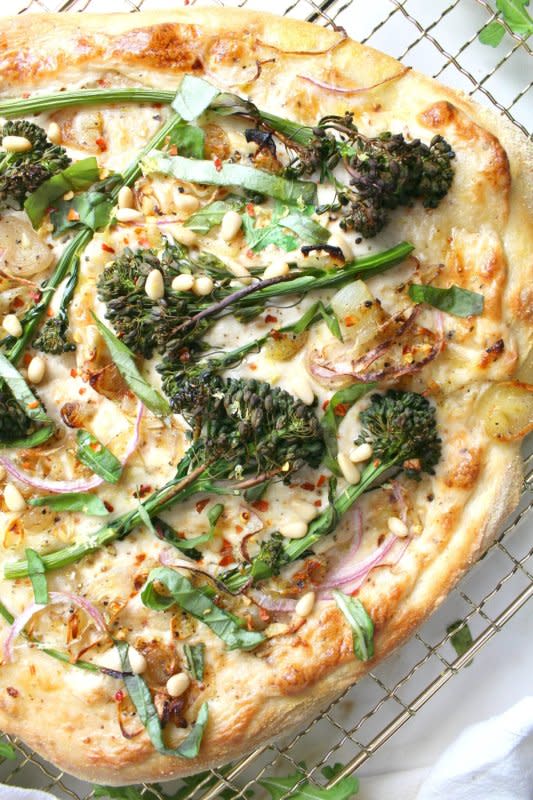 <p>This Savory Vegan</p><p>Restaurant-quality pizza with easy-to-find ingredients—this broccolini and shallot vegan white pizza is loaded with seasoned white sauce, crispy shallots and perfectly cooked broccolini.</p><p><strong>Get the recipe: <a href="https://www.thissavoryvegan.com/broccolini-shallot-vegan-white-pizza/" rel="nofollow noopener" target="_blank" data-ylk="slk:Broccolini Shallot Vegan White Pizza;elm:context_link;itc:0;sec:content-canvas" class="link rapid-noclick-resp">Broccolini Shallot Vegan White Pizza</a></strong></p>