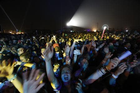 Concertgoers cheer during a performance by Pharrell Williams at the Coachella Valley Music and Arts Festival in Indio, California April 12, 2014. Picture taken April 12, 2012. REUTERS/Mario Anzuoni