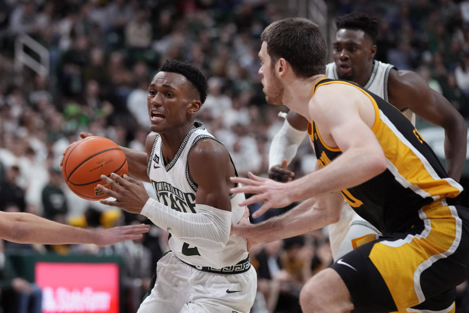 Michigan State guard Tyson Walker (2) drives as Iowa forward Filip Rebraca defends during the second half of an NCAA college basketball game, Thursday, Jan. 26, 2023, in East Lansing, Mich. (AP Photo/Carlos Osorio)