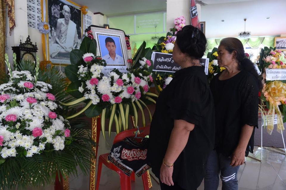 Mourners look at a portrait of 13-year-old Anucha Tasako next to his coffin during his funeral at a Buddhist temple in the Samut Prakan province of Thailand on Wednesday (Romeo Gacad/AFP/Getty Images)