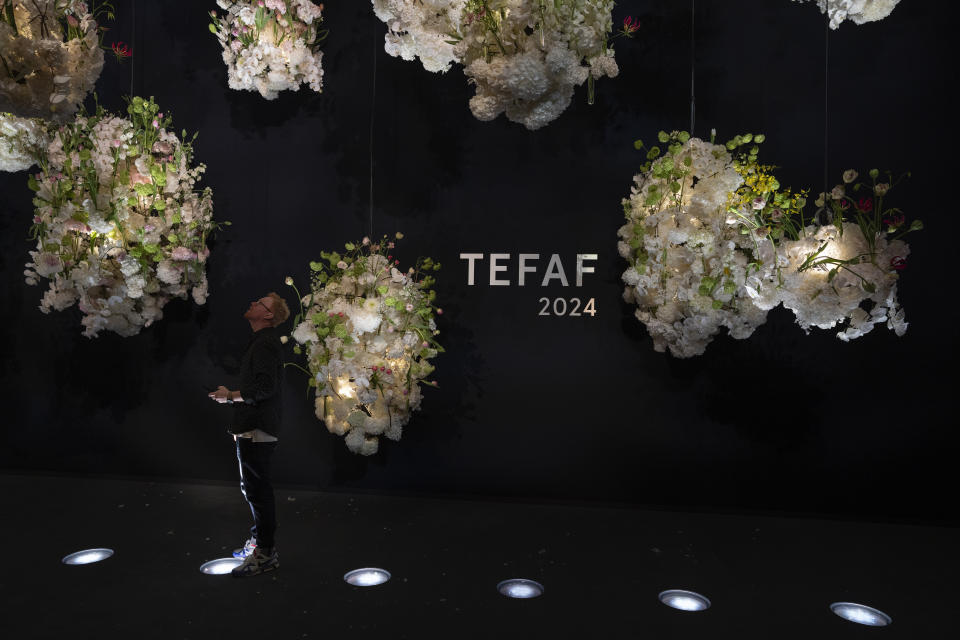 A man looks at floral decorations at the European Fine Art Foundation, known by its acronym TEFAF, in Maastricht, southern Netherlands, Thursday, March 7, 2024. (AP Photo/Peter Dejong)