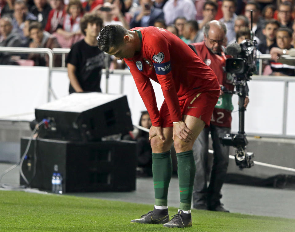 FILE - In this Monday, March 25, 2019 file photo, Portugal's Cristiano Ronaldo reacts during the Euro 2020 group B qualifying soccer match between Portugal and Serbia at the Luz stadium in Lisbon, Portugal. Juventus president Andrea Agnelli has hinted that the Bianconeri might not risk Cristiano Ronaldo for the first match of the Champions League quarterfinals against Ajax. Ronaldo injured a muscle in his right thigh and was forced off after half an hour of Portugal's 1-1 draw against Serbia in qualifying for the 2020 European Championship on Monday. (AP Photo/Armando Franca, FILE )