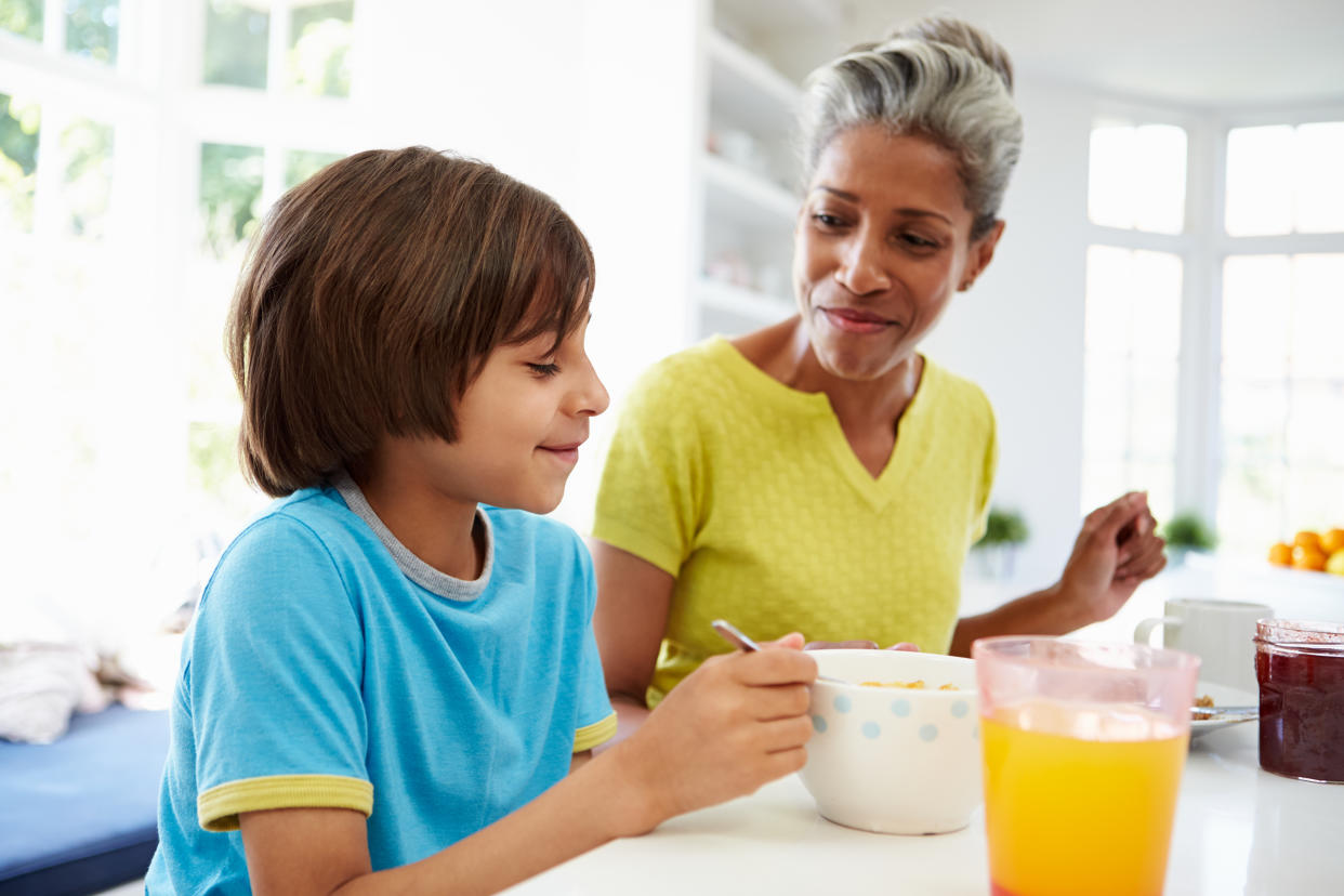 Grandmother and grandson enjoying breakfast with sugar together. (Getty Images)