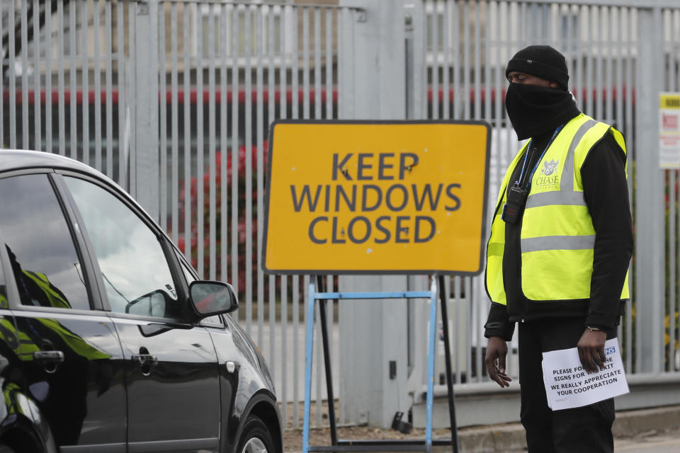 National Health Service staff wait in their cars to take a coronavirus test at a drive through centre in north London, Wednesday, April 1, 2020. The new coronavirus causes mild or moderate symptoms for most people, but for some, especially older adults and people with existing health problems, it can cause more severe illness or death.(AP Photo/Frank Augstein)