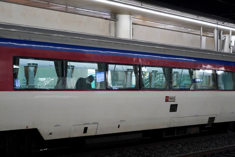 A passenger wearing a mask to prevent contacting the coronavirus sits inside a train at Seoul Railway Station in Seoul