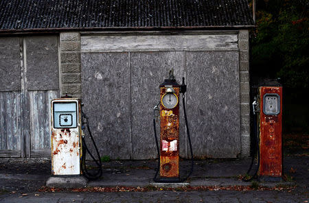 FILE PHOTO: Rusting old petrol pumps outside a long-closed rural village petrol station are seen on a minor road near Trowbridge, Britain, October 21, 2016. REUTERS/Toby Melville/File Photo