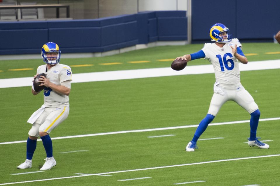 Rams quarterbacks John Wolford, left, and Jared Goff work on a drill Aug. 22, 2020.