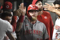 Cincinnati Reds' Jake Fraley is congratulated after he scored against the Pittsburgh Pirates during the eighth inning of a baseball game Friday, Aug. 19, 2022, in Pittsburgh. (AP Photo/Philip G. Pavely)