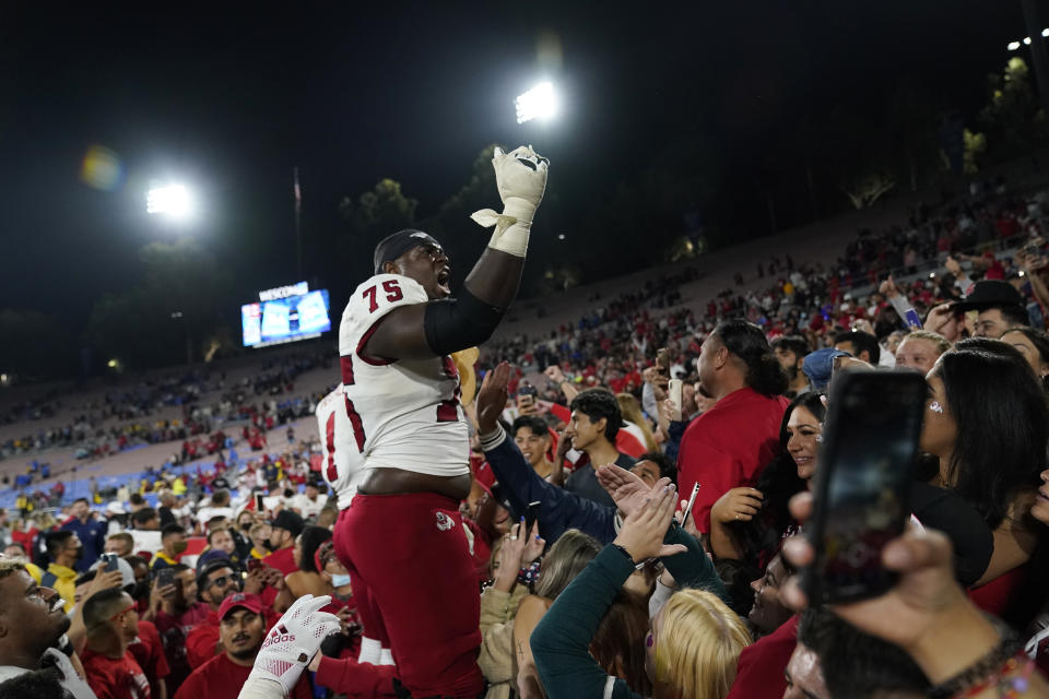 Fresno State offensive lineman Alex Akingbulu (75) celebrates with fans after a win over UCLA in an NCAA college football game Sunday, Sept. 19, 2021, in Pasadena, Calif. (AP Photo/Marcio Jose Sanchez)