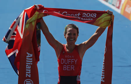 Triathlon - Gold Coast 2018 Commonwealth Games - Women's Final - Southport Broadwater Parklands - Gold Coast, Australia - April 5, 2018 - Flora Duffy of Bermuda celebrates after crossing the finish line in first place. REUTERS/Athit Perawongmetha