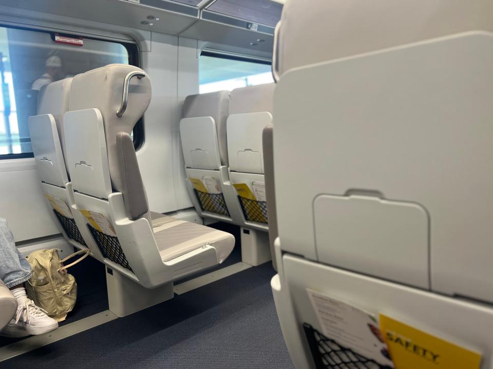 A view of the grey Brightline seats from the side.