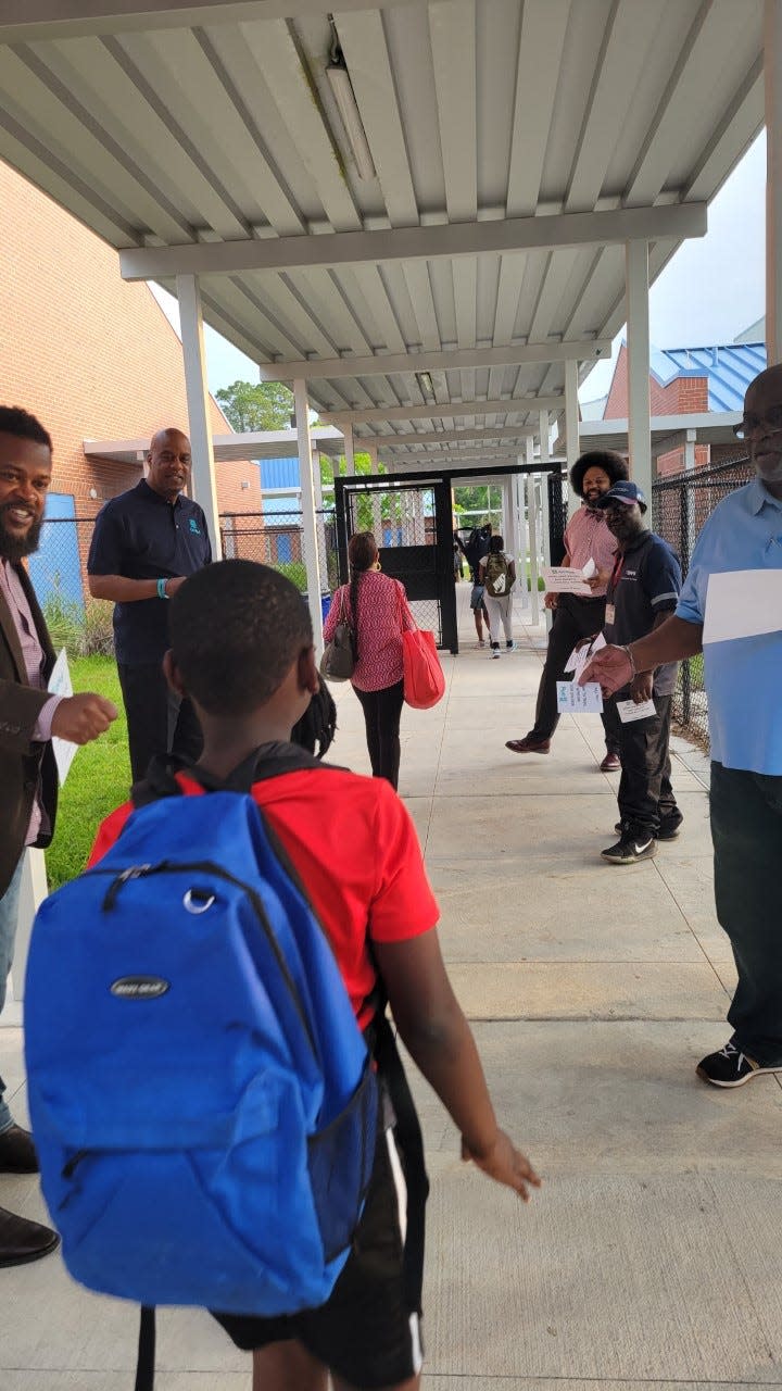 Fathers involved with the Gainesville Fatherhood Initiative participate in the 2nd annual "Cheer Them On Rally" to motivate students at Metcalfe Elementary School in Gainesville to do their best on a state standardized test on Tuesday morning.