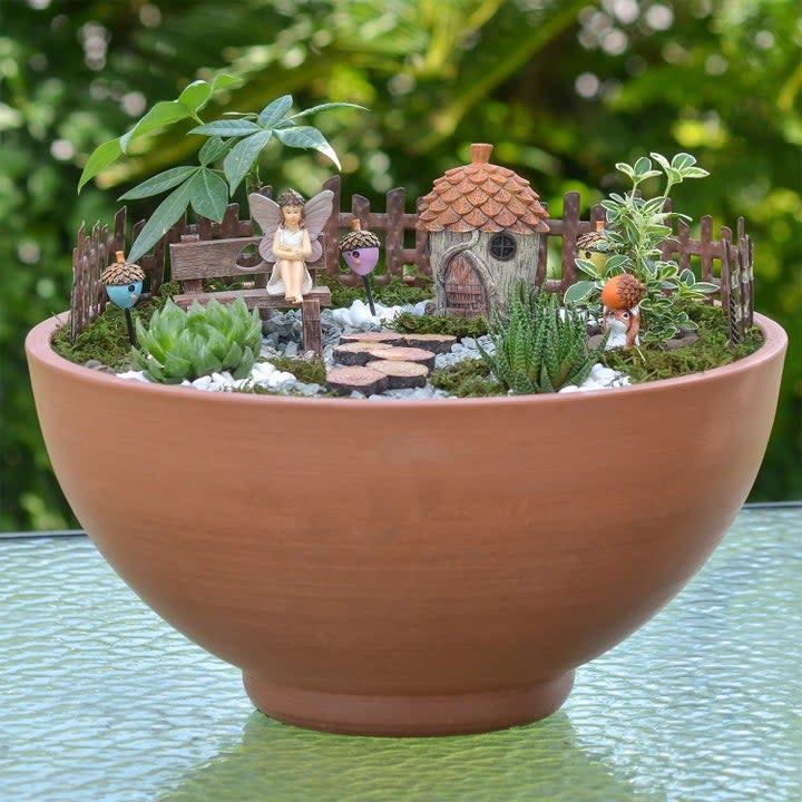 The fairy garden kit set up in a potted plant