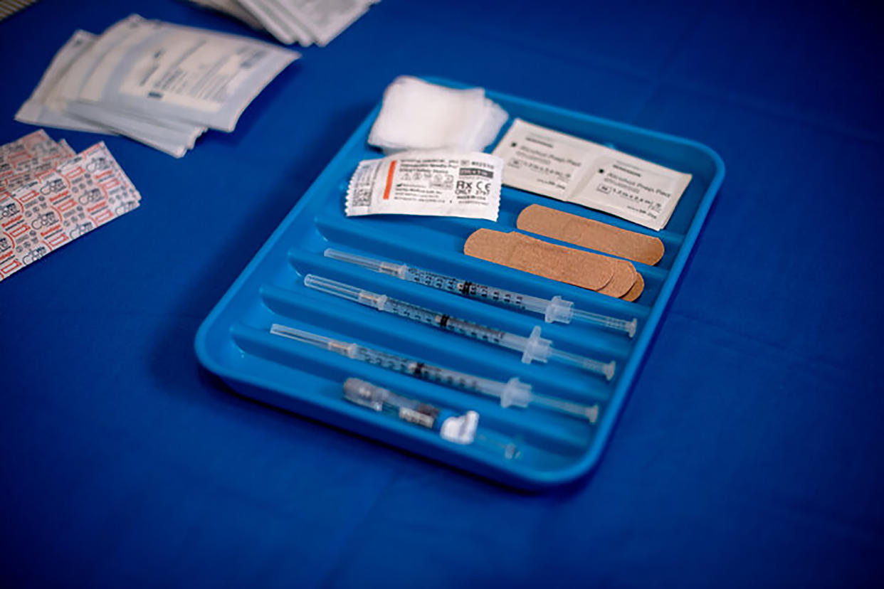 A tray of COVID-19 shots and bandages on a table at a clinic in the Harlem neighborhood of New York, Sept. 19, 2022. (Hilary Swift/The New York Times)