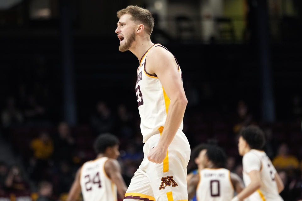 Minnesota forward Parker Fox, front, cheers after a Minnesota basket during the second half of an NCAA college basketball game against Florida Gulf Coast, Saturday, Dec. 9, 2023, in Minneapolis. (AP Photo/Abbie Parr)