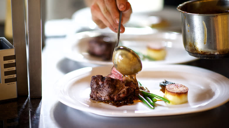 Filet mignon being prepared at restaurant 