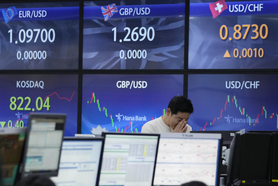 A currency trader reacts near the screens showing foreign exchange rates at the foreign exchange dealing room of the KEB Hana Bank headquarters in Seoul, South Korea, Thursday, Nov. 30, 2023. Asian shares were mostly higher Thursday ahead of an update on U.S. consumer inflation and a meeting of oil producers in Vienna. (AP Photo/Ahn Young-joon)