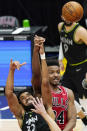 Minnesota Timberwolves center Karl-Anthony Towns, left, and Chicago Bulls center Wendell Carter Jr., battle for a rebound during the second half of an NBA basketball game in Chicago, Wednesday, Feb. 24, 2021. (AP Photo/Nam Y. Huh)