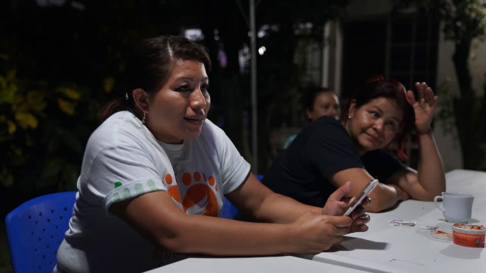 Vásquez sits with friends and fellow members of her organization, Mujeres Libres, in May 2022. The group aims to help other women who've been released from prison after convictions related to obstetric emergencies, and to educate Salvadoran youth so that "history does not repeat itself." - Jessie Wardarski/AP