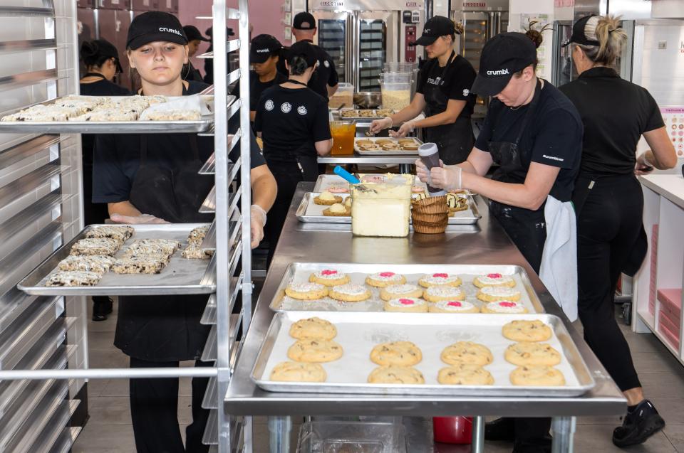 Crumbl Cookies employees were busy making and baking cookies on Wednesday at the chain's new location at 4414 SW College Road, Suite 325, in Market Street at Heath Brook in Ocala. The official grand opening is Friday.