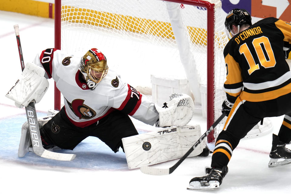Ottawa Senators goaltender Joonas Korpisalo (70) blocks a shot by Pittsburgh Penguins' Drew O'Connor (10) during the third period of an NHL hockey game in Pittsburgh, Saturday, Oct. 28, 2023. (AP Photo/Gene J. Puskar)