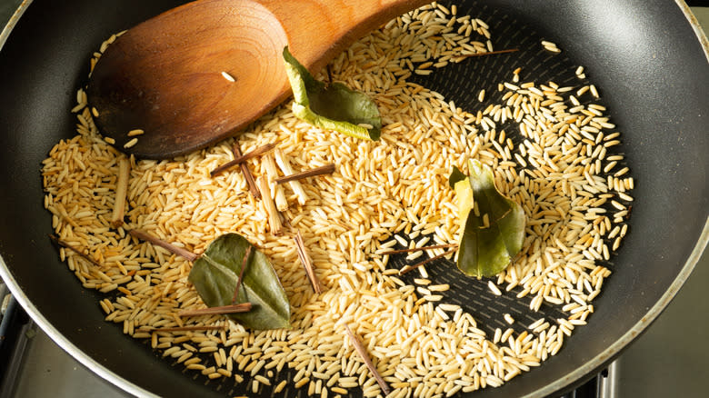 rice being toasted in pan