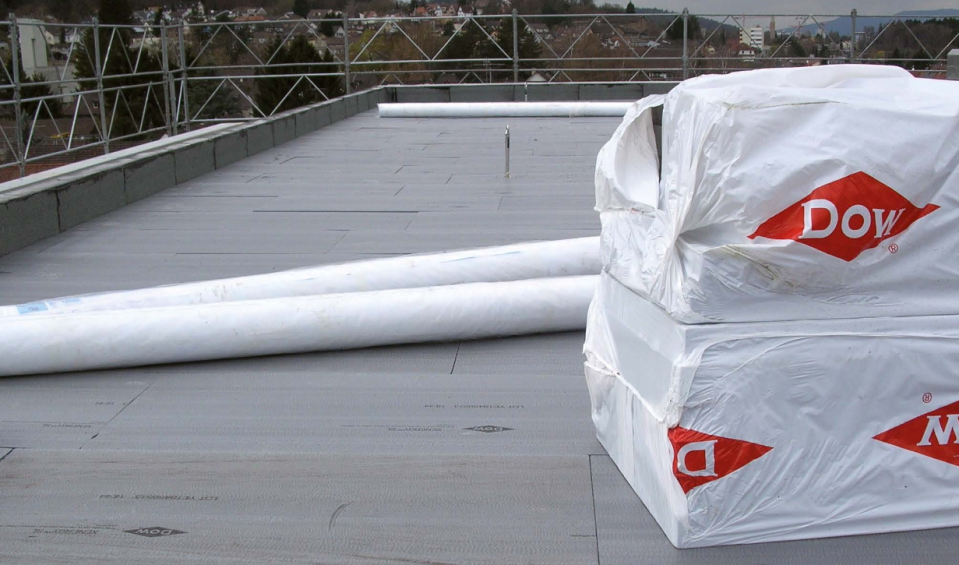 Two piles of Dow-wrapped materials on a roof.