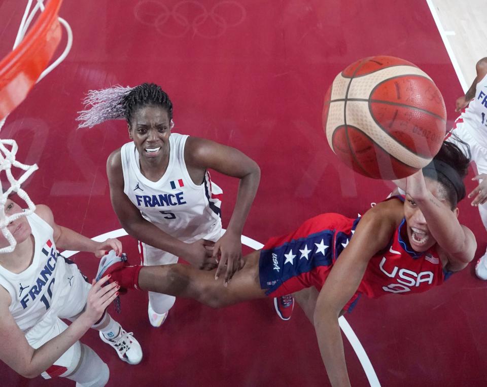 A'ja Wilson shoots while being defended by France player Sarah Michel.