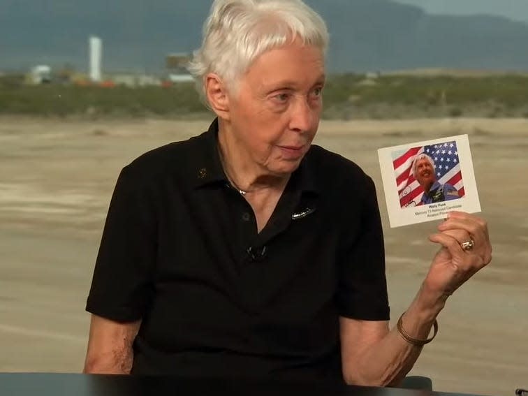 Wally Funk holds a photo of herself.