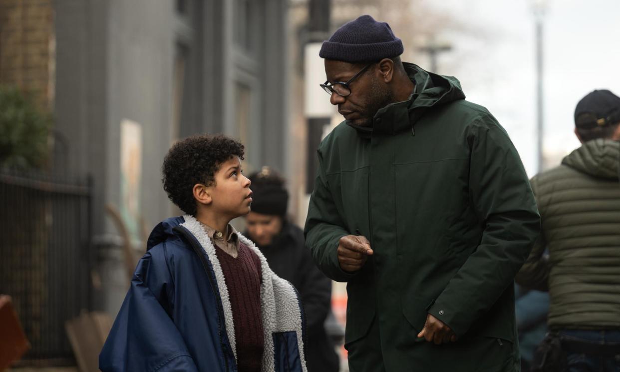 <span>Elliott Heffernan and Steve McQueen on the set of Blitz. He says he used the child’s gaze ‘to refocus our own gaze as adults’.</span><span>Photograph: Parisa Taghizadeh/Apple TV+</span>