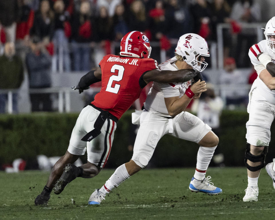 ATHENS, GA - NOVEMBER 11: Jaxson Dart #2 of the Mississippi Rebels tries to avoid Smael Mondon Jr.#2 of the Georgia Bulldogs during a game between University of Mississippi and University of Georgia at Sanford Stadium on November 11, 2023 in Athens, Georgia. (Photo by Steve Limentani/ISI Photos/Getty Images)