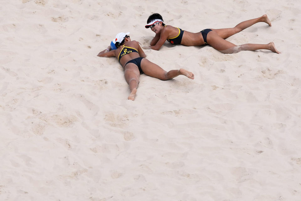 BEIJING - AUGUST 19: Wang Jie of China and teammate Tian Jia lay on the sand after trying to dig a ball during the Women's Semifinal match against China at the Chaoyang Park Beach Volleyball Ground on Day 11 of the Beijing 2008 Olympic Games on August 19, 2008 in Beijing, China. (Photo by Nick Laham/Getty Images)