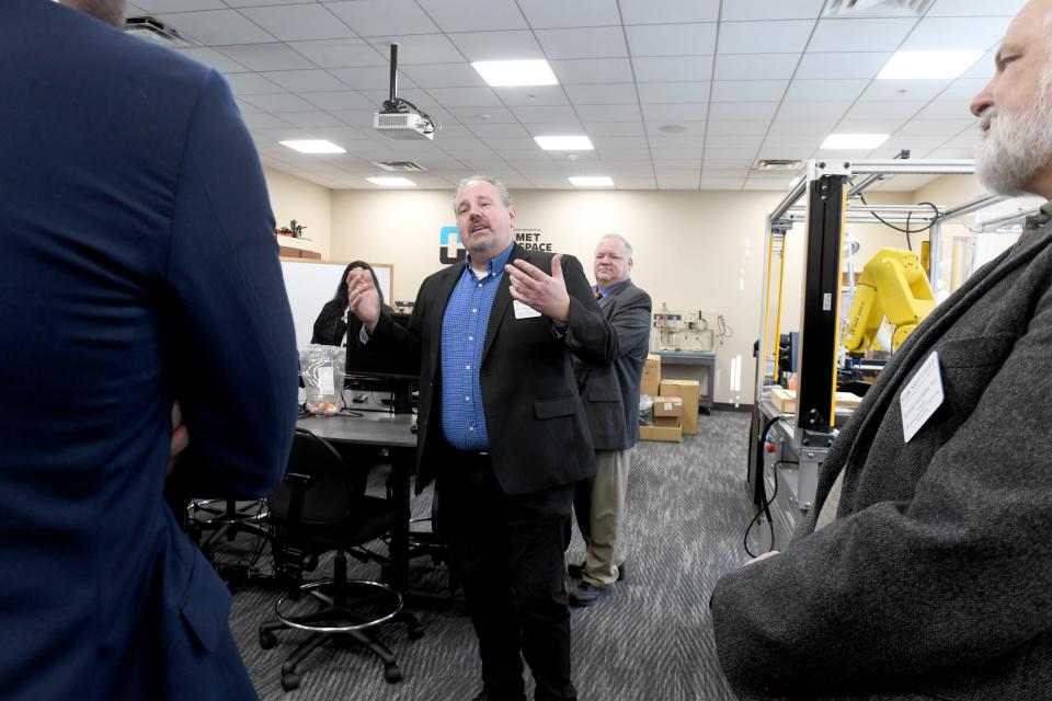 Donald Ball, dean of business, engineering and information technologies at Stark State College, leads a tour for Intel representatives on campus Friday for the school's new Intel/Dell AI lab in the W.R. Timken Center for Information Technology.