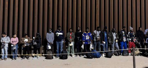 PHOTO: Migrants wait to be processed by Border Patrol agents after crossing illegally the border between the United States and Mexico, in Yuma, Ariz.., on May 10, 2023. (Etienne Laurent/EPA via Shutterstock)