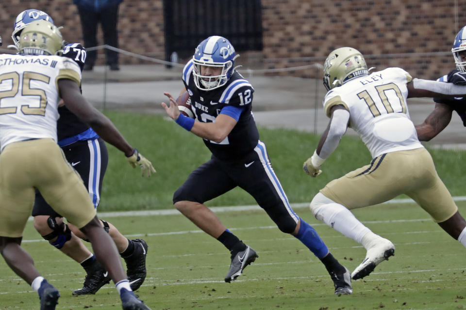 Duke quarterback Gunnar Holmberg (12) runs against Georgia Tech linebacker Charlie Thomas (25) and linebacker Ayinde Eley (10) during the first half of an NCAA college football game in Durham, N.C., Saturday, Oct. 9, 2021. (AP Photo/Chris Seward)