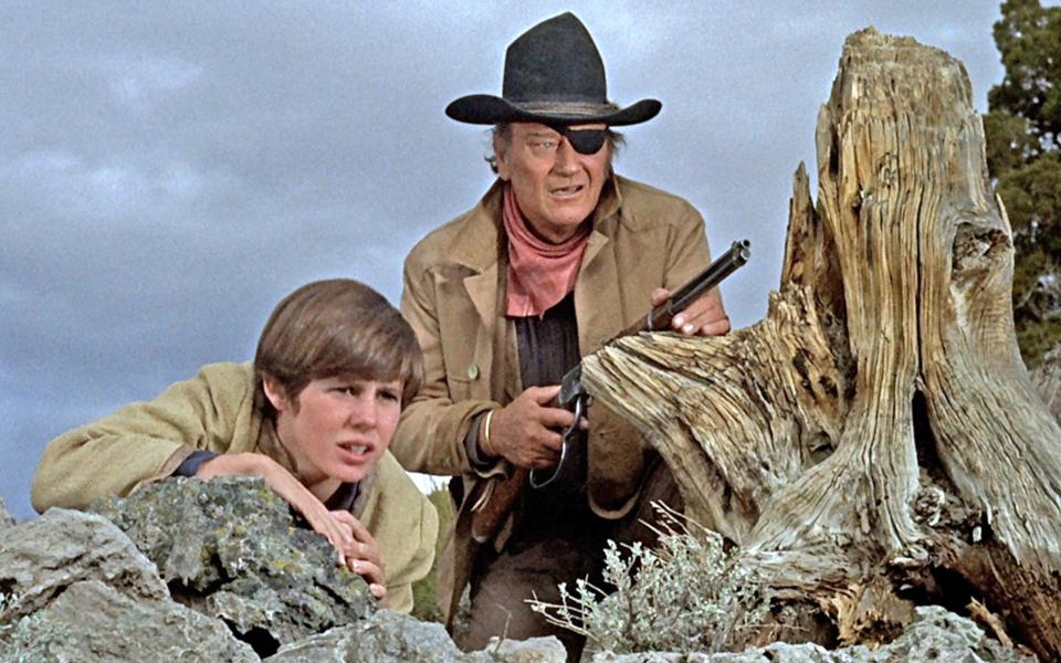 Wayne alongside Kim Darby in True Grit (1969) - Alamy