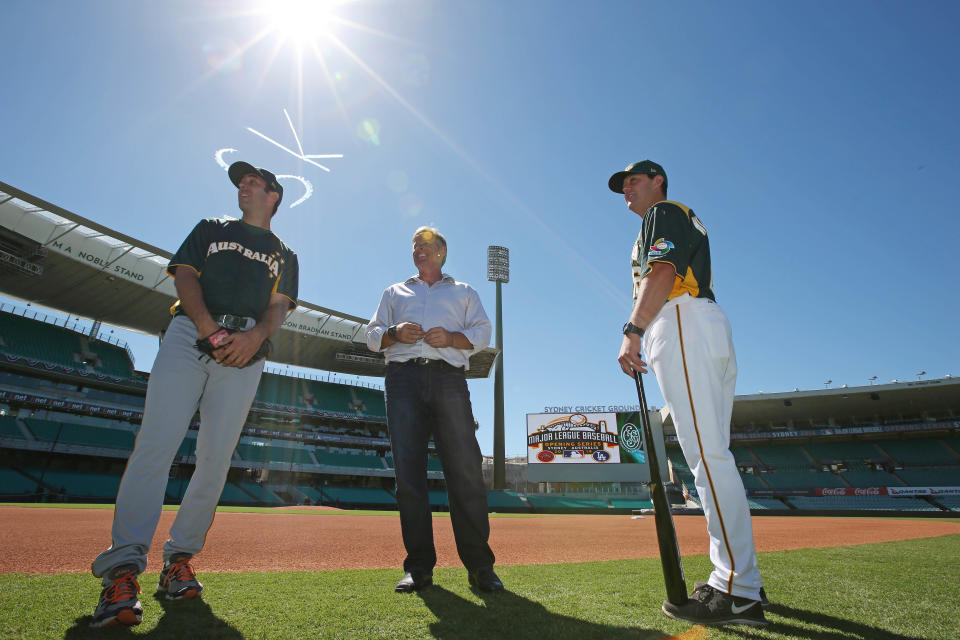 Australian Baseball player Craig Anderson, left, and coaches Jon Deeble and Glenn Williams, right, inspect the baseball field especially built for the Major League Baseball opening series at the Sydney Cricket Ground in Sydney, Monday, March 17, 2014. The MLB season-opening two-game series between the Los Angeles Dodgers and Arizona Diamondbacks in Sydney will be played this weekend. (AP Photo/Rick Rycroft)