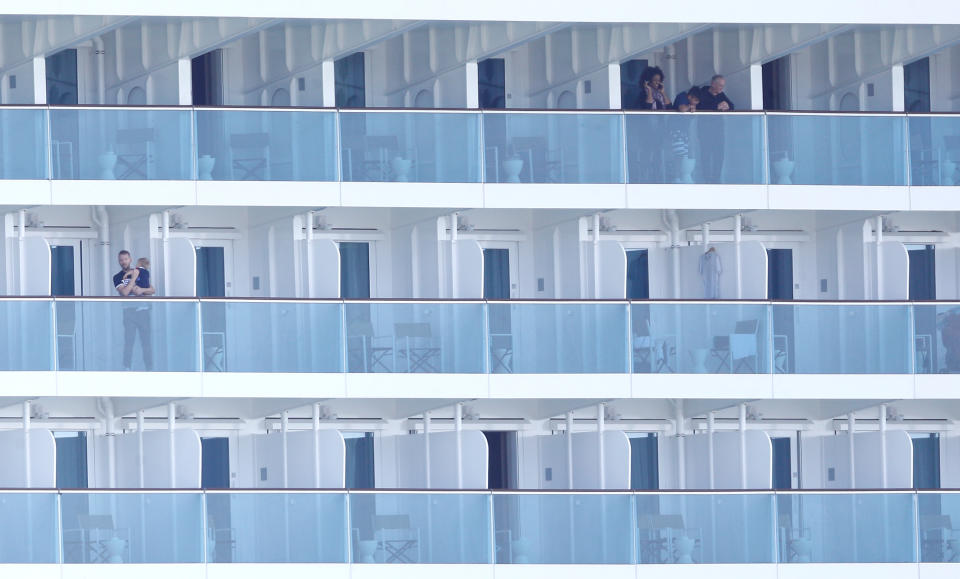 Passengers are seen onboard the Costa Smeralda cruise ship of Costa Crociere, carrying around 6,000 passengers, as it sits docked at the Italian port of Civitavecchia following a health alert due to a Chinese couple and a possible link to coronavirus, in Civitavecchia, Italy, January 30, 2020. REUTERS/Guglielmo Mangiapane