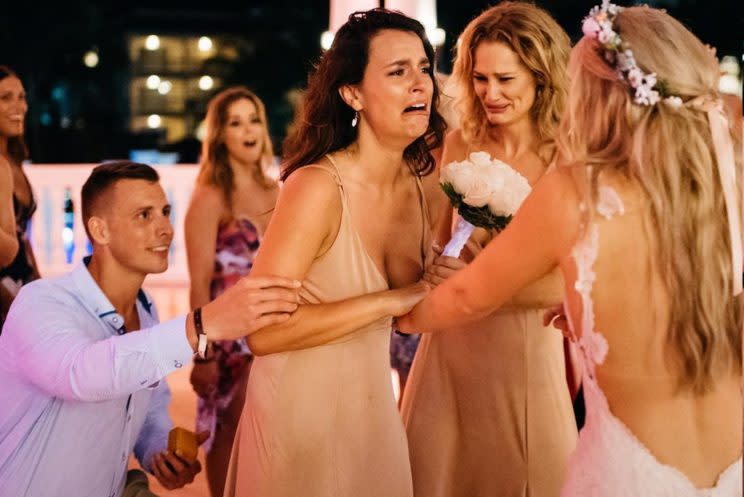 This bride planned a surprise proposal for her best friend. [Photo: Ross Dance Photography]