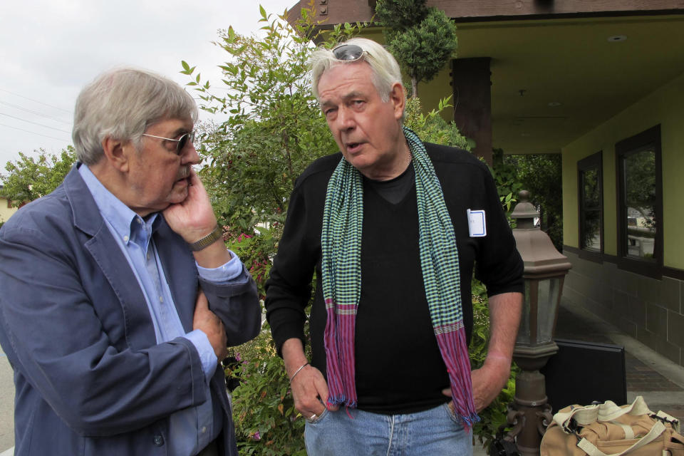 FILE - Richard Pyle, former Associated Press bureau chief in Saigon, left, stands with with war photographer Tim Page during a Vietnam journalists reunion in Garden Grove California, May 13, 2011. Legendary Vietnam War photographer, writer and counter-culture documenter Tim Page died Wednesday, Aug. 24, 2022 at his Australian home. He was 78 years old. (AP Photo/Nick Ut, File)