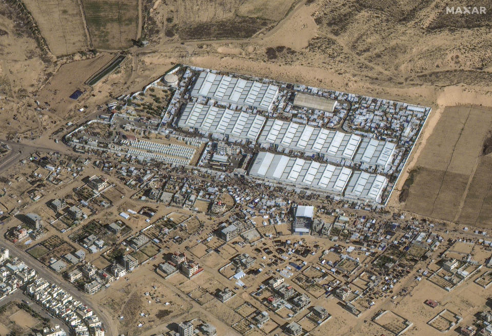 FILE - This satellite image provided by Maxar Technologies shows crowds of people and shelters at a U.N. aid center and camp, in Rafah, southern Gaza, on Sunday, Dec. 3, 2023. Tens of thousands of people have fled from Khan Younis and other areas to Rafah, on Gaza's southern border with Egypt, the U.N. said. (Satellite image ©2023 Maxar Technologies via AP, File)