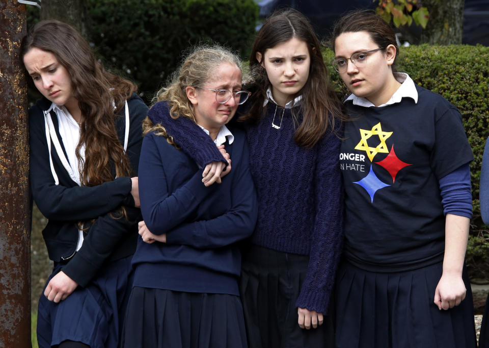 FILE - Students from the Yeshiva School in the Squirrel Hill neighborhood of Pittsburgh pay their respects as the funeral procession for Dr. Jerry Rabinowitz passes their school en route to Homewood Cemetery on Oct. 30, 2018, following a funeral service at the Jewish Community Center. Rabinowitz was one of several people killed in a mass shooting while worshipping at the Tree of Life synagogue three days earlier. (AP Photo/Gene J. Puskar, File)