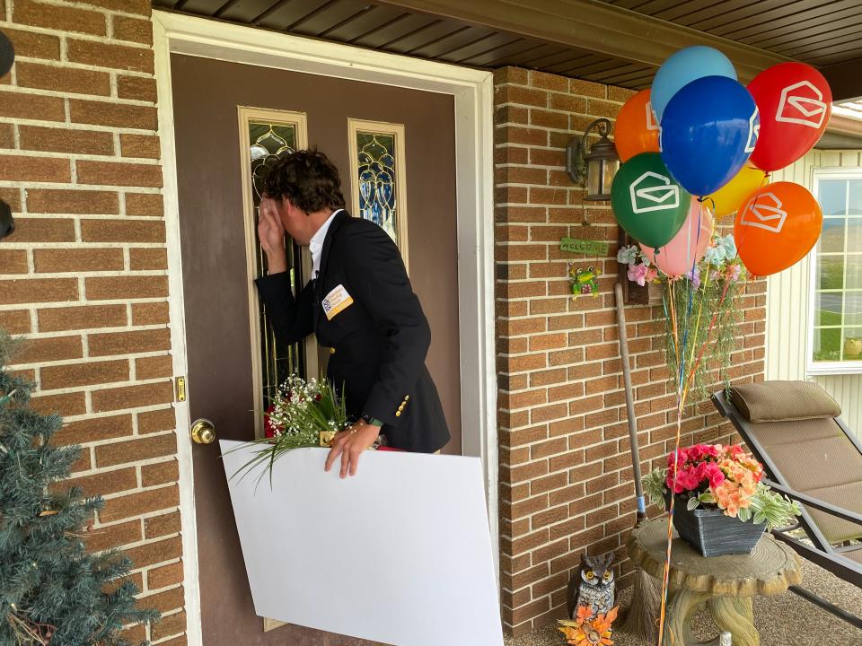 Howie Guja of the Publishers Clearing House Prize Patrol peeped in a window of the door at the home of Rodney Small on Edenville Road outside of Chambersburg, looking for the PCH Lotto $1 million prize winner on May 16.