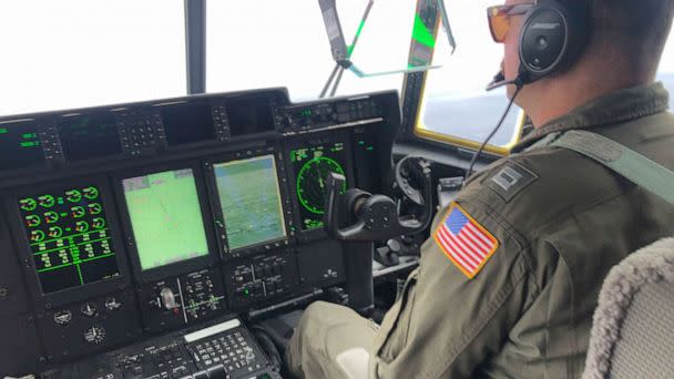 PHOTO: A crew member sits aboard a Coast Guard HC-130 Hercules airplane as it flies about 900 miles East of Cape Cod, Mass., during the search for the submersible Titan, June 21, 2023. (Petty Officer 1st Class Amber Howie/U.S. Coast Guard via AP)