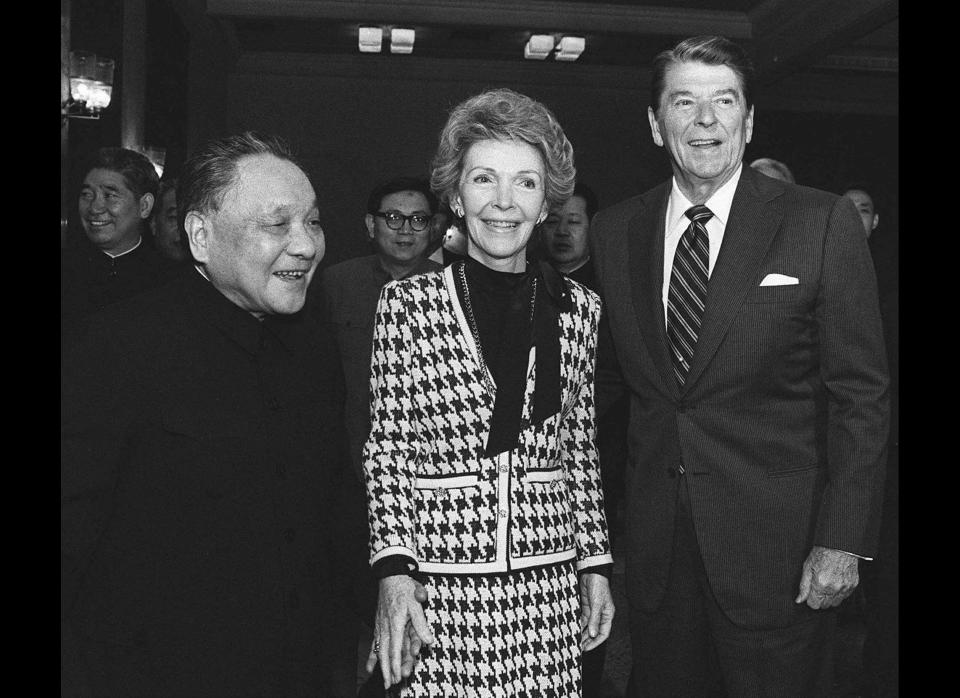 Chinese leader Deng Xiaoping holds hands with U.S. first lady Nancy Reagan with U.S. President Ronald Reagan in Beijing April 28, 1984.