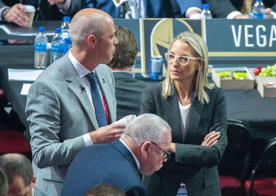 FILE - Vancouver Canucks hockey team assistant general manager Emilie Castonguay talks to general manager Patrik Allvin during the first round of the NHL draft in Montreal, Thursday, July 7, 2022. At the start of 2022, there were no women serving as assistant general managers in the NHL. Now there are five. (Graham Hughes/The Canadian Press via AP, File)