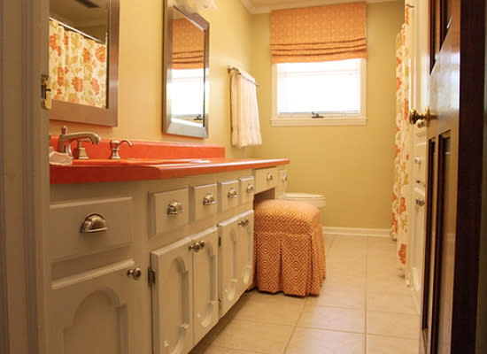 <body> <p>While it's hard to believe when you see the after photos, most of the elements were untouched. The floors, tub, tile, cabinets, sink, and countertop—<em>yes</em>, even the <a rel="nofollow noopener" href=" http://www.bobvila.com/slideshow/trending-now-laminate-countertops-25494?bv=yahoo" target="_blank" data-ylk="slk:orange countertop;elm:context_link;itc:0;sec:content-canvas" class="link ">orange countertop</a>—all remain. Replacing the gaudy foil wallpaper with a paintable vinyl successor and painting the cabinet base white accomplished most of the heavy lifting, while the warm hues in the contemporary fabric choices tie the reimagined orange scheme together.</p> <p><strong>Related: <a rel="nofollow noopener" href=" http://www.bobvila.com/slideshow/7-very-different-looks-for-bathroom-vanities-2387#.Va-uaypViko?bv=yahoo" target="_blank" data-ylk="slk:7 (Very) Different Looks for Bathroom Vanities;elm:context_link;itc:0;sec:content-canvas" class="link ">7 (Very) Different Looks for Bathroom Vanities</a> </strong> </p> </body>
