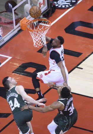 May 21, 2019; Toronto, Ontario, CAN; Toronto Raptors forward Norman Powell (24) shoots the ball past Milwaukee Bucks forward Giannis Antetokounmpo (34) and Bucks guard Pat Connaughton (24) during the fourth quarter in game four of the Eastern conference finals of the 2019 NBA Playoffs at Scotiabank Arena. Mandatory Credit: Nick Turchiaro-USA TODAY Sports