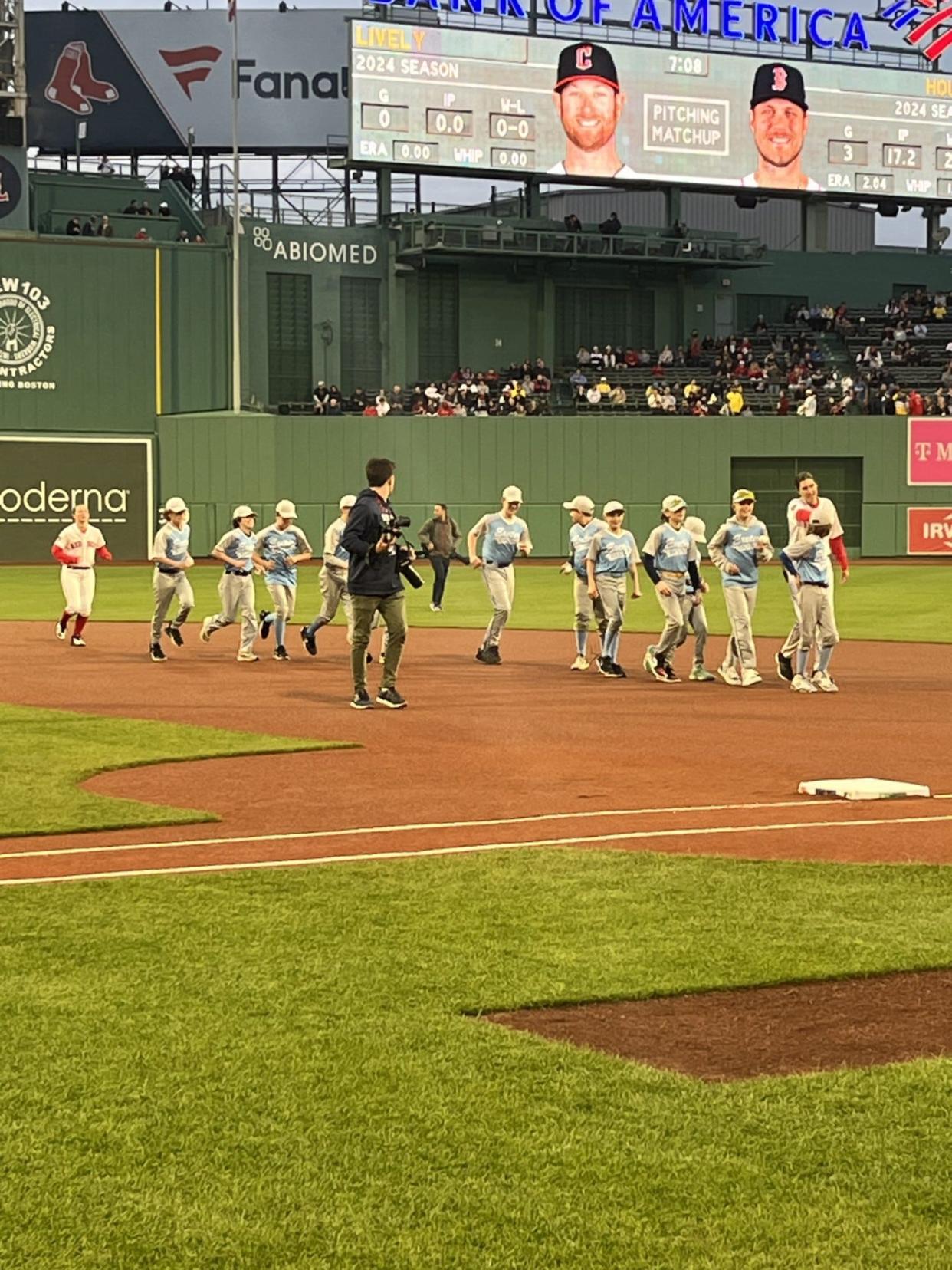 The Exeter Cal Ripken team of 12-and-under baseball players made an appearance on the field at Fenway Park in Boston, shaking hands with Red Sox players, Wednesday, April 17, 2024.